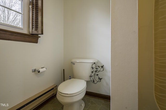 bathroom featuring tile patterned flooring, a baseboard radiator, and toilet