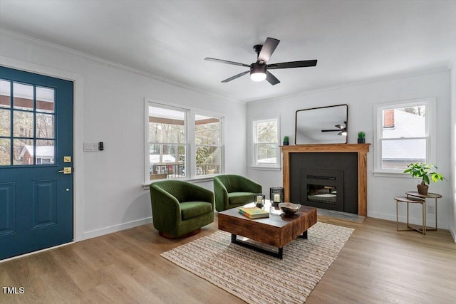 living room with crown molding and light hardwood / wood-style floors