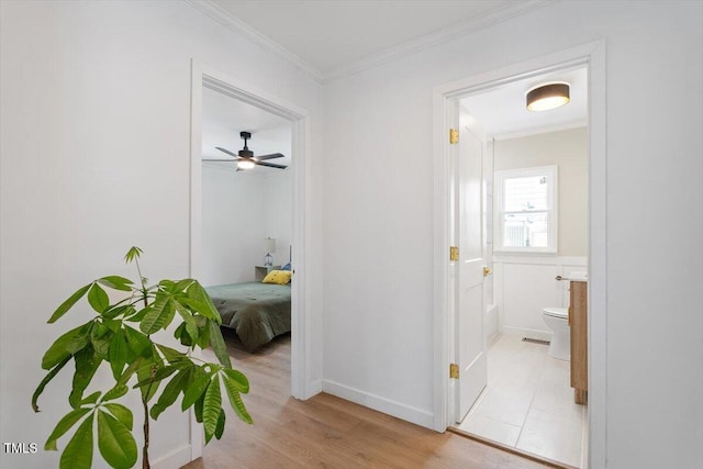 hall featuring crown molding and light wood-type flooring