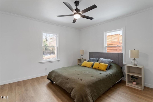 bedroom with crown molding, ceiling fan, and light wood-type flooring