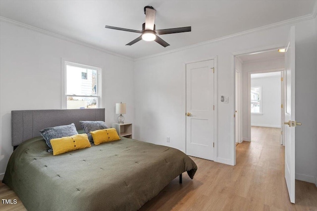 bedroom featuring crown molding, ceiling fan, and light hardwood / wood-style flooring