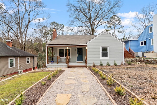 bungalow-style house featuring a porch and a front yard