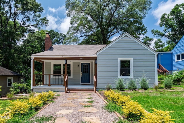 1606 James St, Durham, NC 27707 - view of front of property with covered porch, a chimney, and a shingled roof