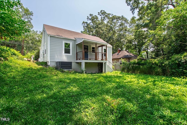 1606 James St, Durham, NC 27707 - back of property with a shingled roof, stairway, and a lawn