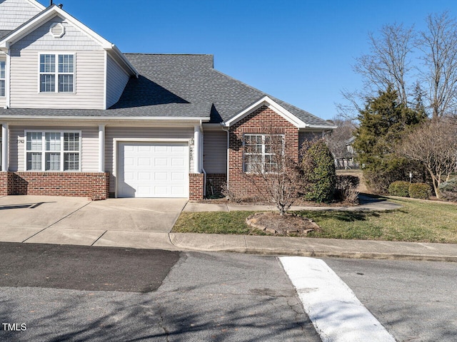 view of front of home featuring a garage, driveway, brick siding, and a shingled roof