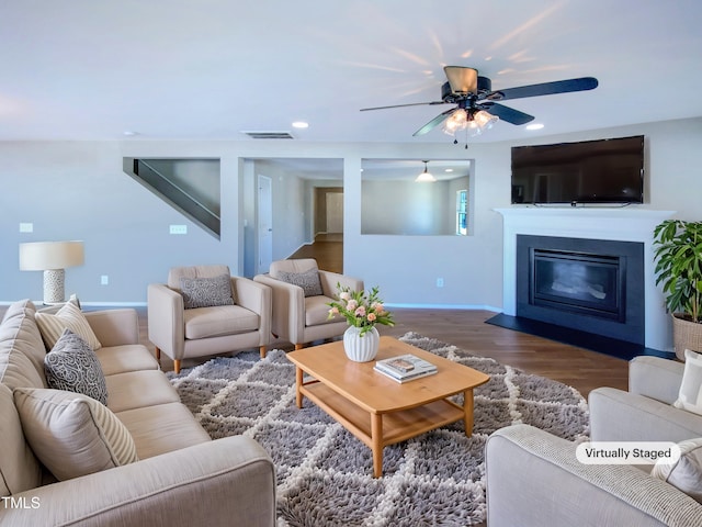 living room featuring ceiling fan and hardwood / wood-style floors