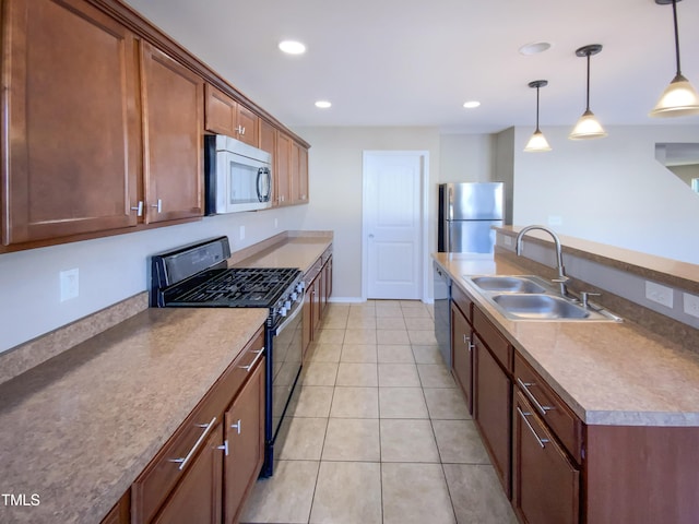 kitchen with sink, decorative light fixtures, light tile patterned floors, and appliances with stainless steel finishes