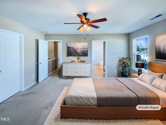 carpeted bedroom featuring ceiling fan and ensuite bathroom