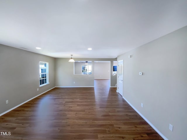 unfurnished room featuring ceiling fan and dark hardwood / wood-style floors