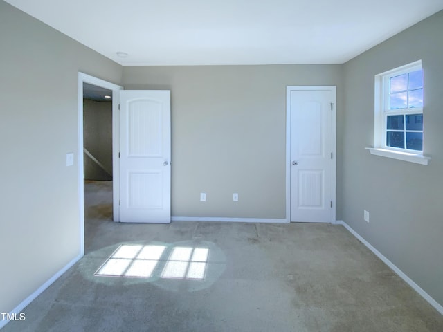 unfurnished bedroom with light carpet