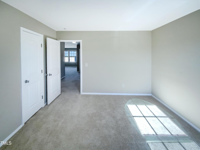 unfurnished room with light colored carpet