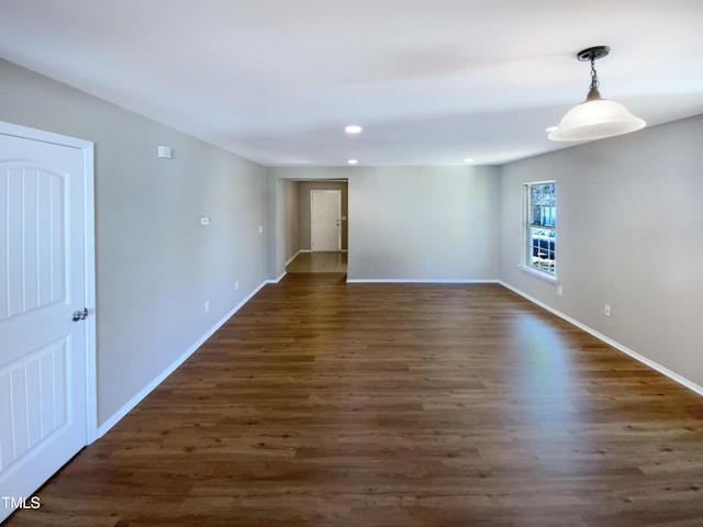 spare room with dark wood-type flooring