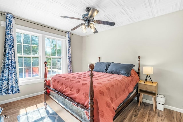 bedroom with ceiling fan and wood-type flooring