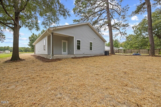 exterior space with cooling unit and a lawn