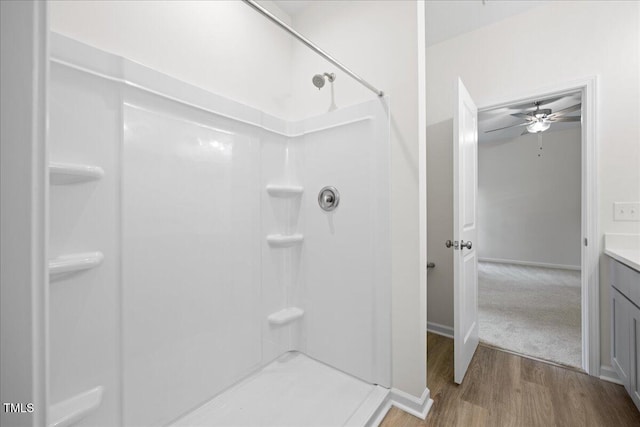 bathroom with vanity, wood-type flooring, ceiling fan, and walk in shower