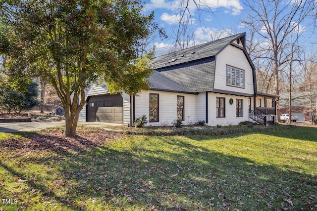 view of front of property with a garage and a front lawn