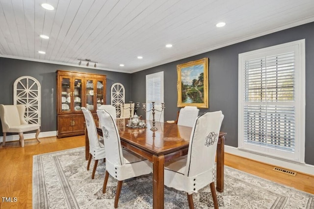 dining space featuring wood ceiling, ornamental molding, rail lighting, and light wood-type flooring