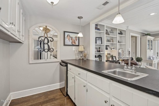 kitchen featuring white cabinetry, hanging light fixtures, dark hardwood / wood-style flooring, and sink