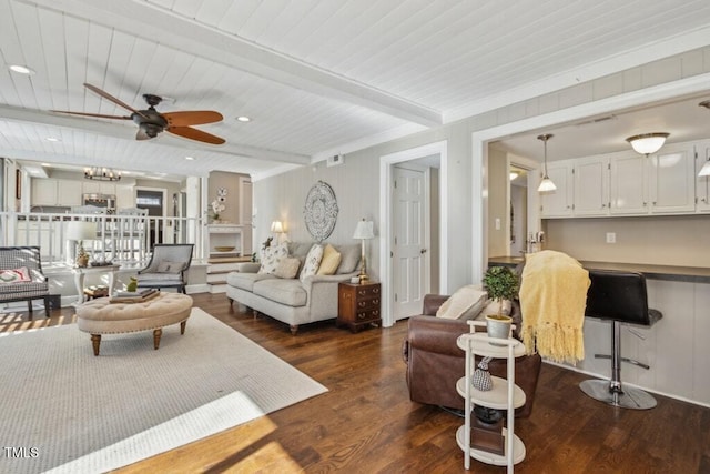 living room with beamed ceiling, ceiling fan, and dark hardwood / wood-style flooring