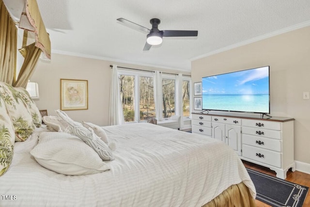 bedroom featuring crown molding, wood-type flooring, and ceiling fan