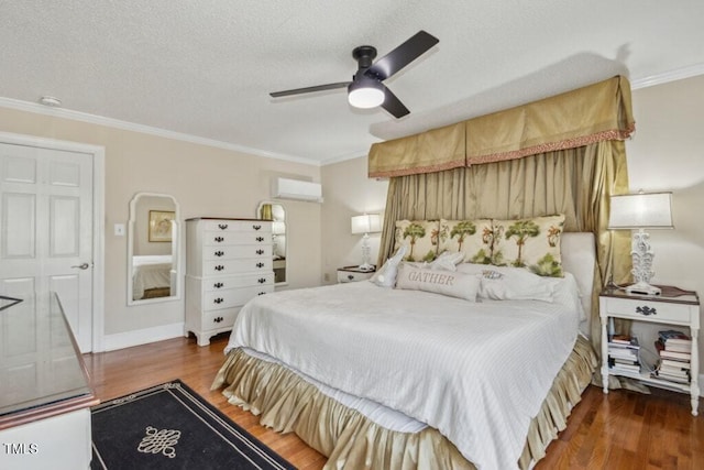 bedroom with a wall mounted air conditioner, a textured ceiling, ornamental molding, dark hardwood / wood-style floors, and ceiling fan