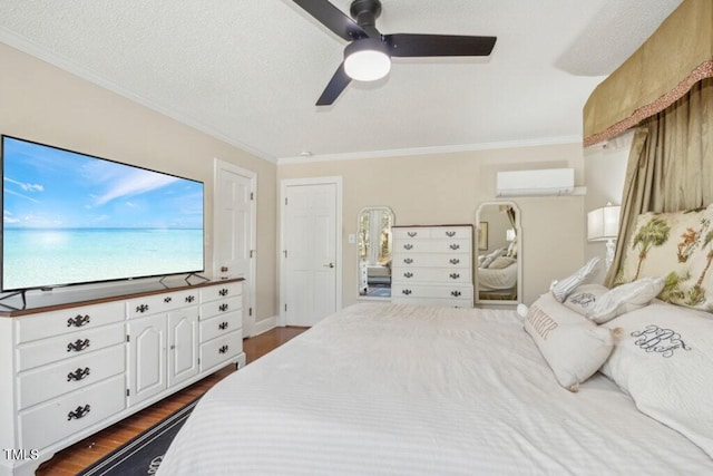 bedroom with ornamental molding, dark hardwood / wood-style floors, a textured ceiling, and an AC wall unit