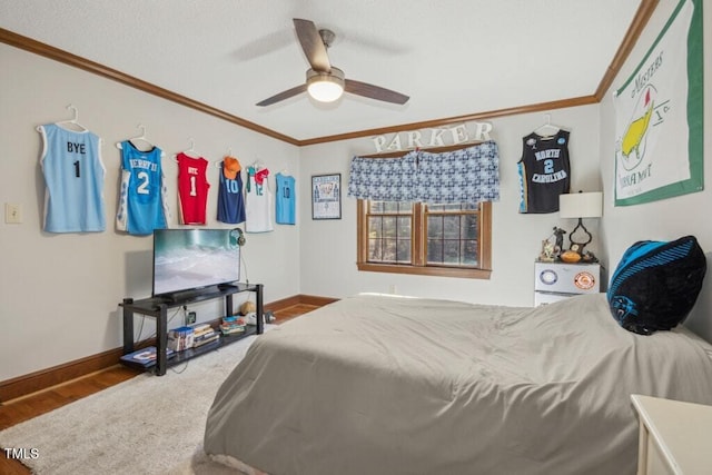 bedroom featuring crown molding, wood-type flooring, and ceiling fan