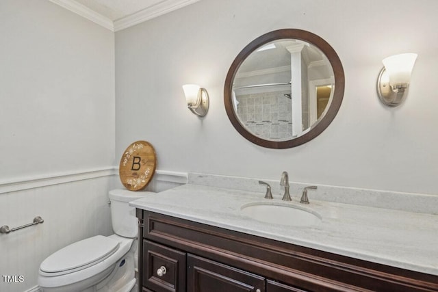 bathroom featuring crown molding, vanity, toilet, and a shower