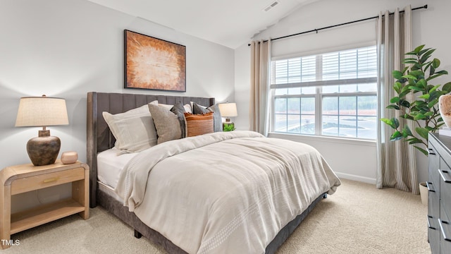 carpeted bedroom with lofted ceiling