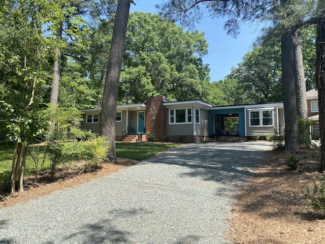 single story home featuring a carport