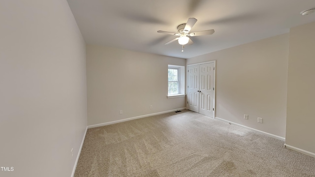 carpeted empty room with ceiling fan