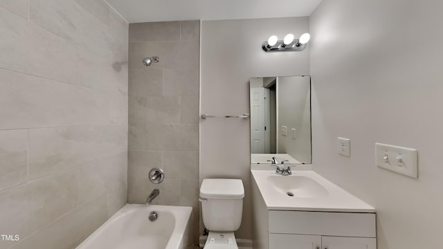 full bathroom featuring tiled shower / bath combo, toilet, and vanity