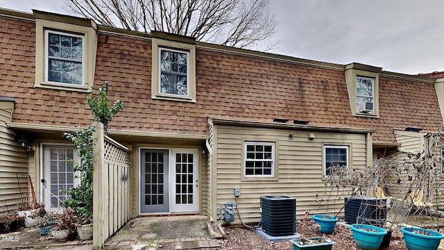 back of house with central AC unit