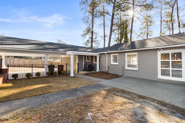 exterior space featuring central AC and a yard