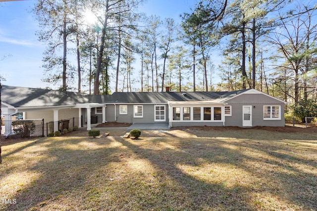 rear view of property featuring a lawn and a patio