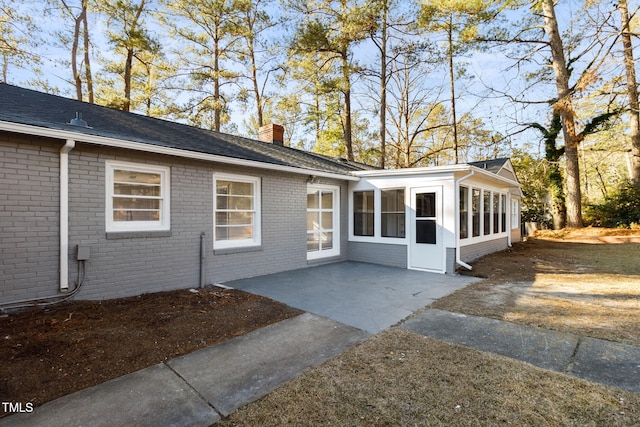 exterior space featuring a sunroom and a patio