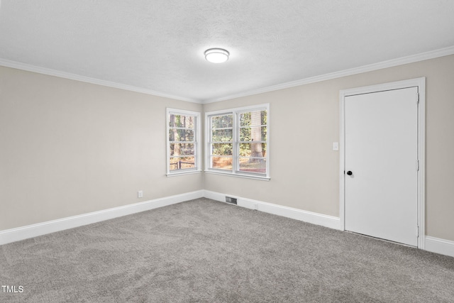 empty room featuring crown molding and carpet flooring