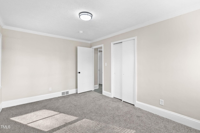 unfurnished bedroom with carpet floors, a closet, and ornamental molding