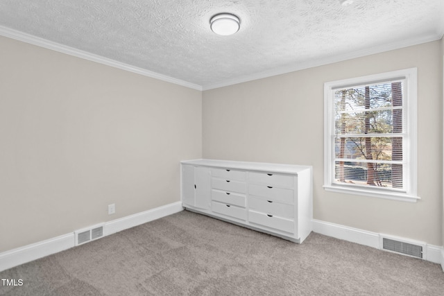 unfurnished bedroom featuring a textured ceiling, crown molding, and light carpet