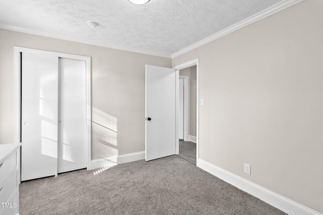 unfurnished bedroom with light colored carpet, a closet, crown molding, and a textured ceiling