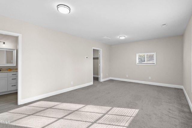 unfurnished room featuring light colored carpet