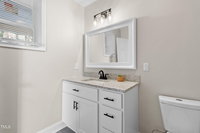 bathroom featuring toilet and vanity