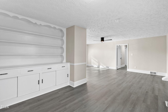 interior space featuring a textured ceiling and dark hardwood / wood-style flooring