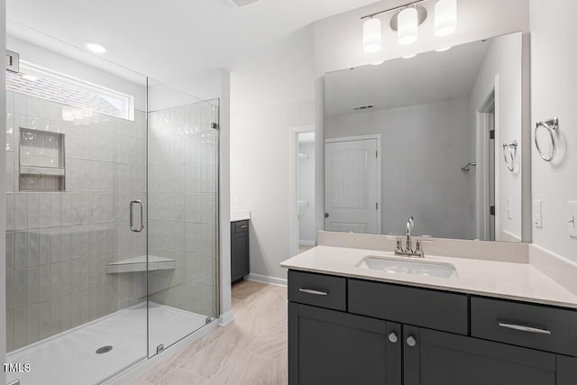 bathroom with vanity, marble finish floor, a stall shower, and visible vents