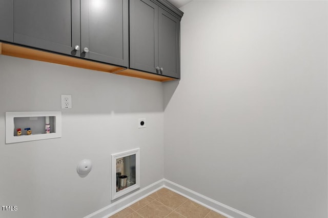 clothes washing area featuring hookup for a washing machine, hookup for an electric dryer, light tile patterned flooring, cabinet space, and baseboards