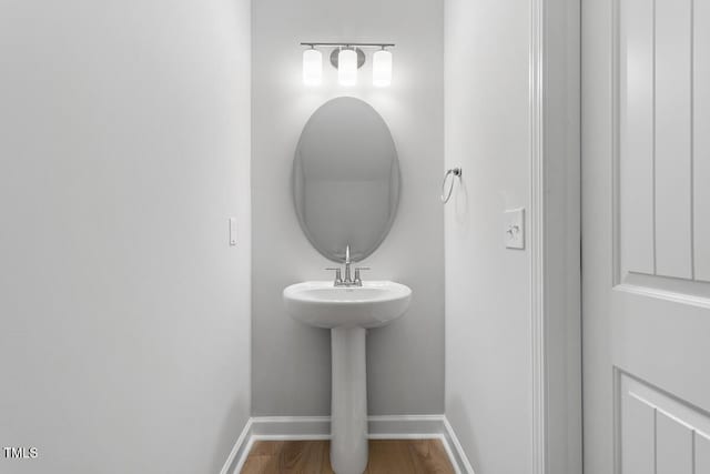 bathroom featuring baseboards and wood finished floors