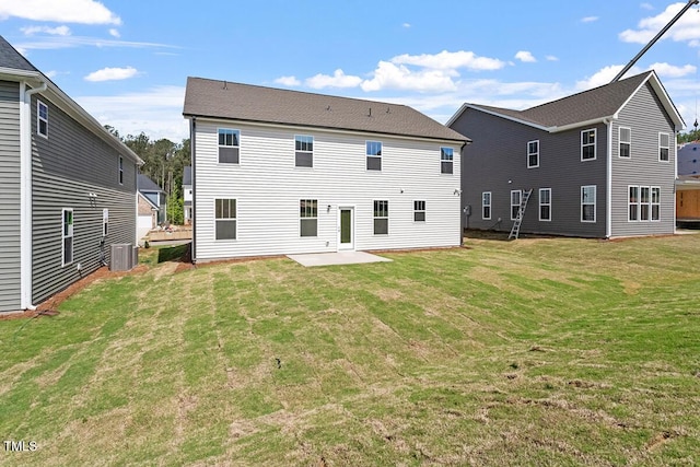 rear view of house with central AC, a yard, and a patio area