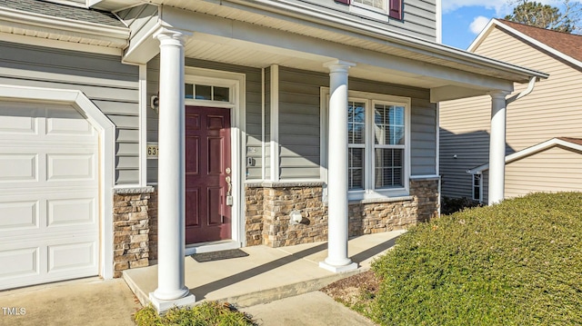 entrance to property with a garage and a porch