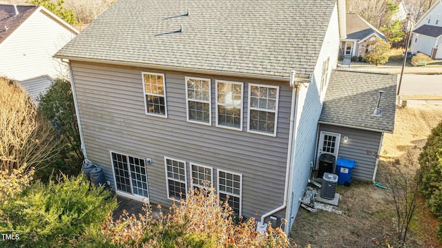 rear view of house featuring central AC