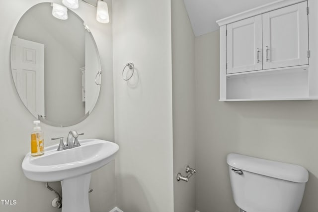 bathroom featuring toilet and vaulted ceiling